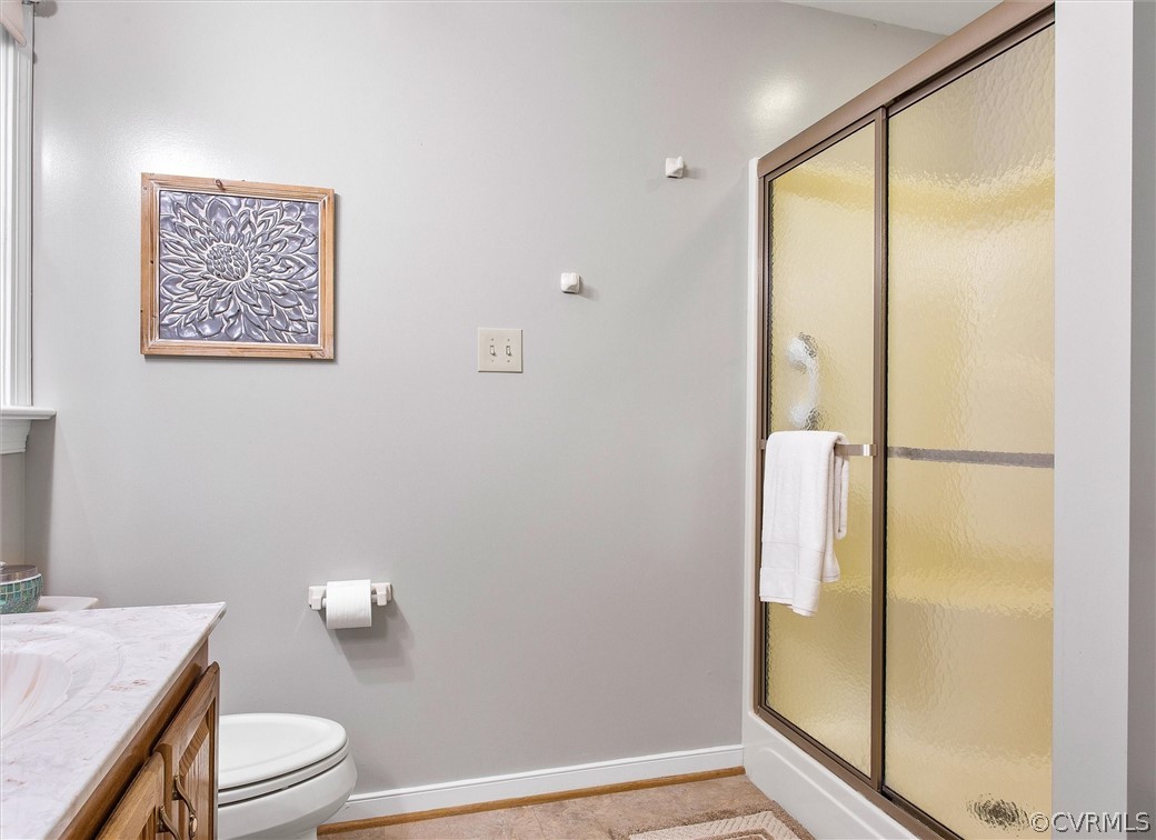 2763 Checketts Drive Sandy Hook, VA 23153 - Photo 30 of 36 a bathroom with a granite countertop sink toilet and shower