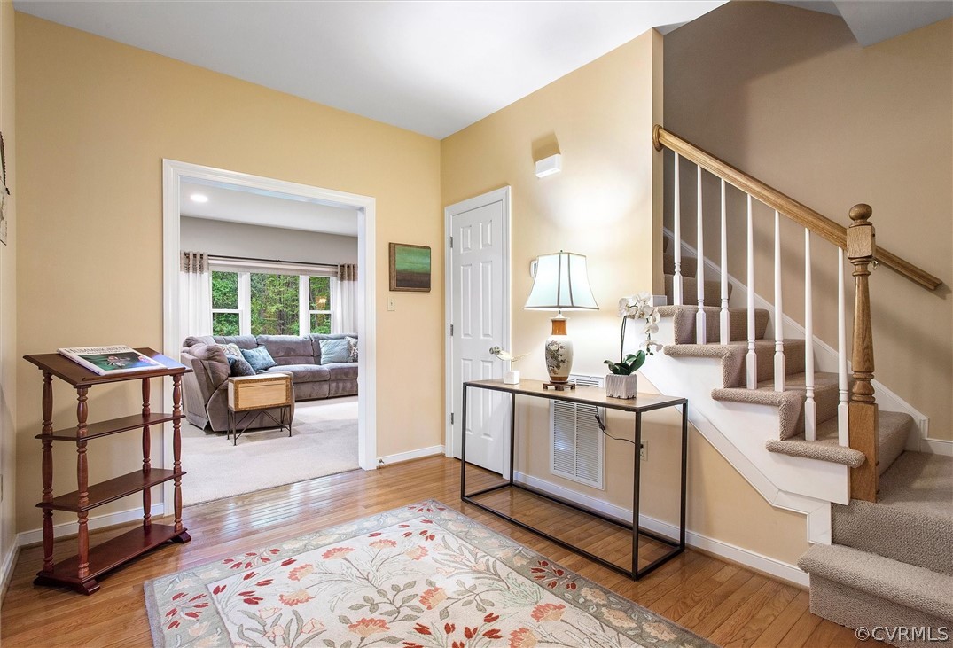 2763 Checketts Drive Sandy Hook, VA 23153 - Photo 7 of 36 a living room with stainless steel appliances furniture a rug and a wooden floor