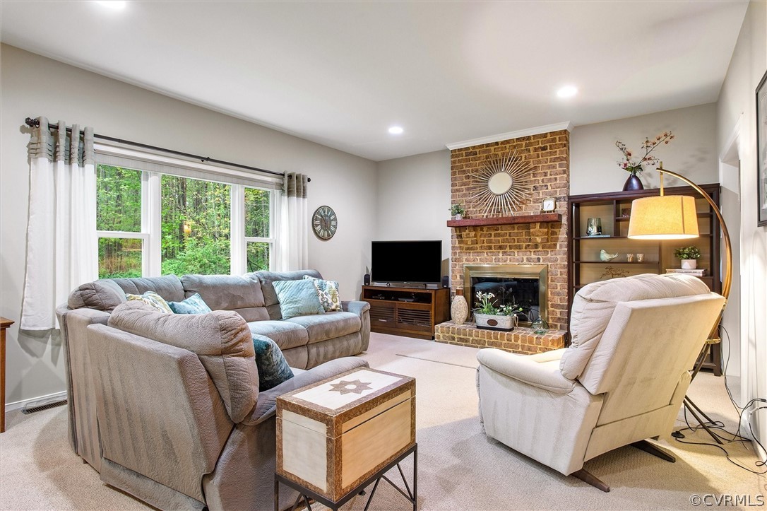2763 Checketts Drive Sandy Hook, VA 23153 - Photo 8 of 36 a living room with furniture a large window and a fireplace