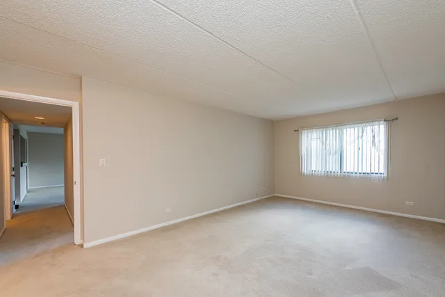 an empty room with a empty space and windows