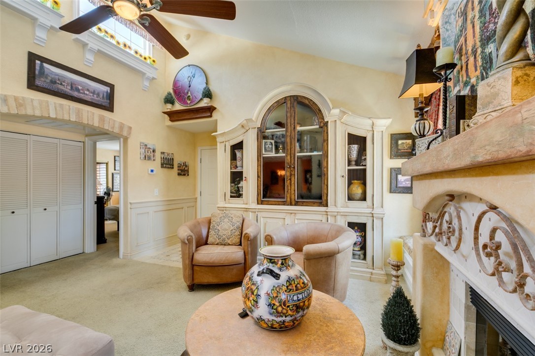 9325 West Desert Inn Road, Unit 244 Las Vegas, NV 89117 - Photo 9 of 55 Vaulted ceilings and a decorative fireplace create a cozy, inviting atmosphere.