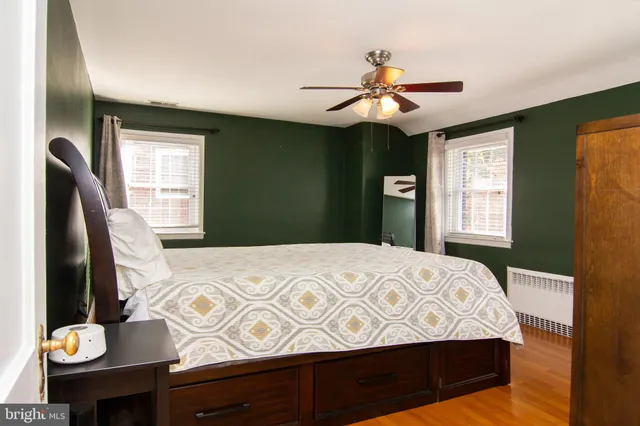 a bedroom with a bed dresser and a window