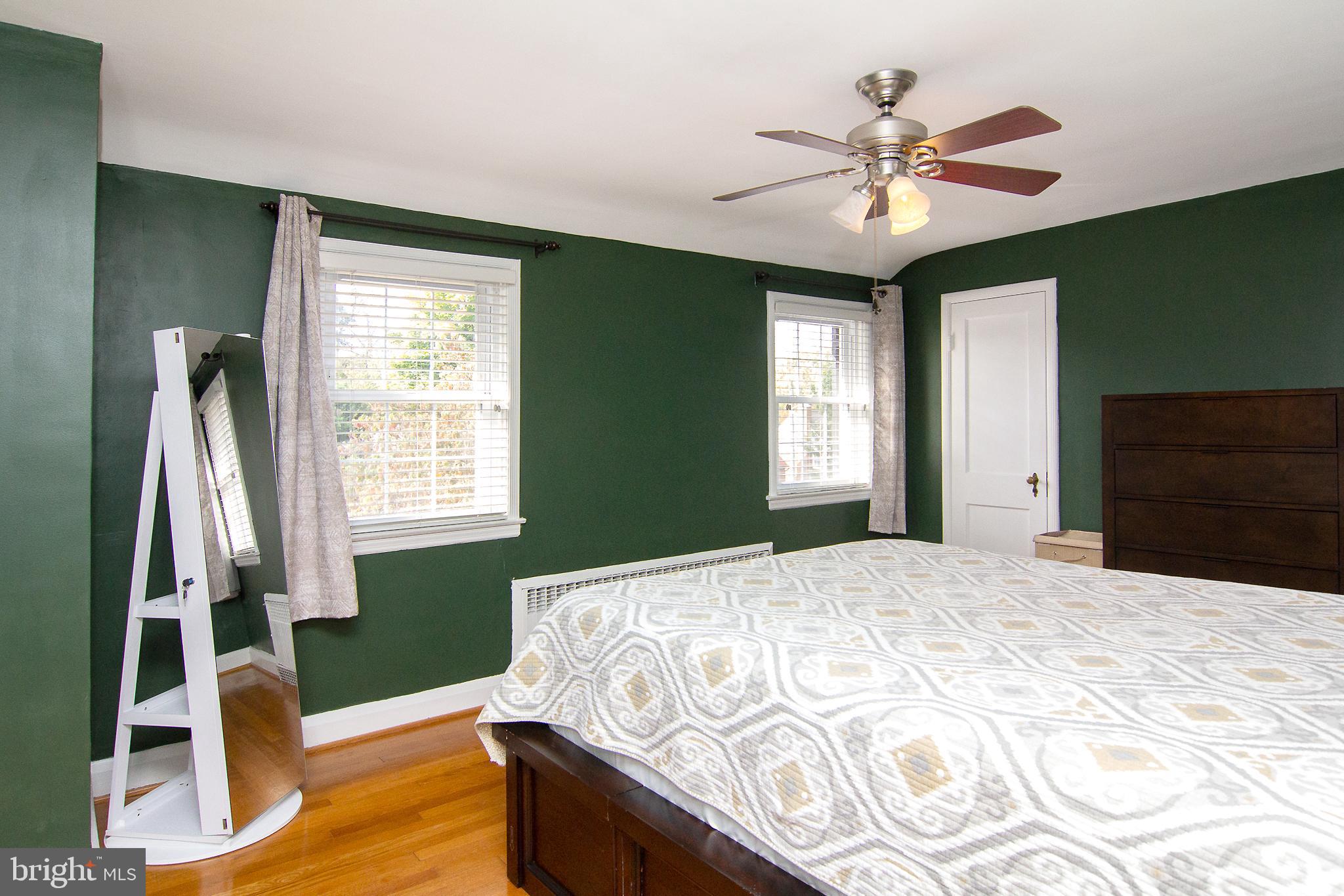 636 Overbrook Road Baltimore, MD 21212 - Photo 27 of 38 a bedroom with a bed and a chandelier
