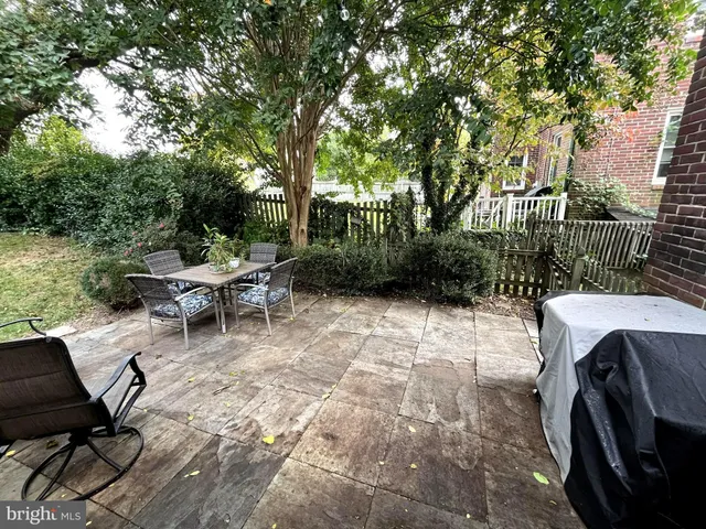 a view of backyard with seating area and green space