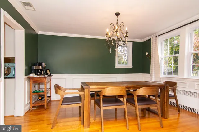 a dining room with furniture a rug and a chandelier