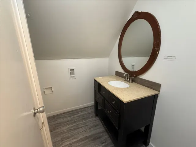a bathroom with a sink a vanity and a mirror