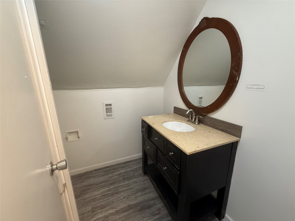 622 Trinity Street Lockhart, TX 78644 - Photo 11 of 16 a bathroom with a sink a vanity and a mirror