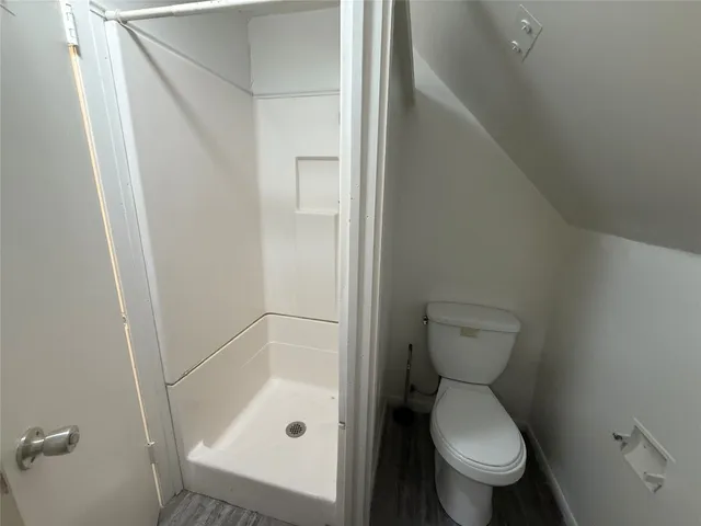 a bathroom with a toilet and a shower