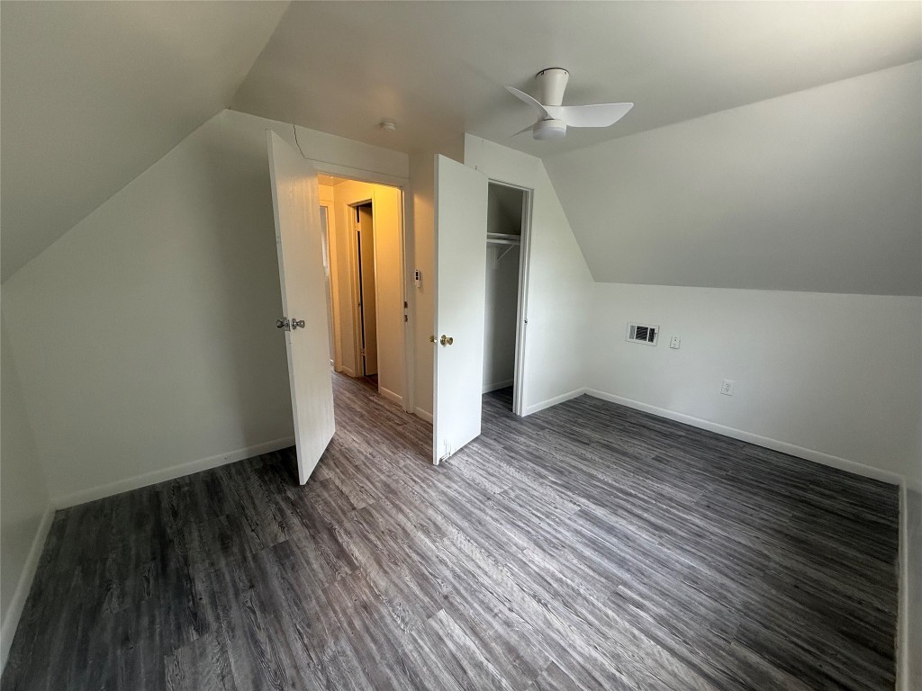 622 Trinity Street Lockhart, TX 78644 - Photo 13 of 16 an empty room with wooden floor and a ceiling fan