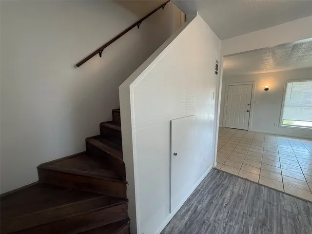a view of entryway and hall with wooden floor