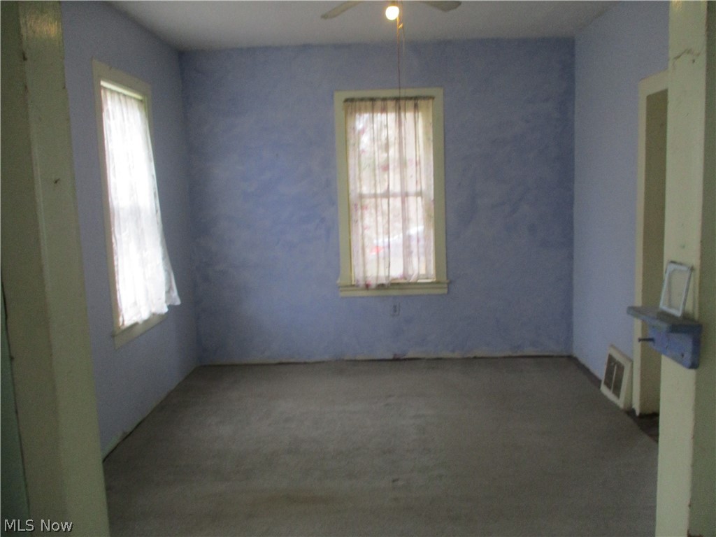14831 Calaboone Road Doylestown, OH 44230 - Photo 9 of 14 Carpeted spare room with ceiling fan