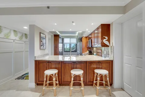 a kitchen with cabinets and chairs
