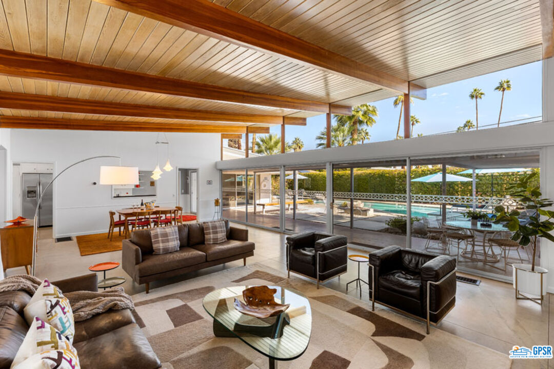 1090 Sagebrush Road Palm Springs, CA 92264 - Photo 1 of 49 a living room with furniture and a floor to ceiling window