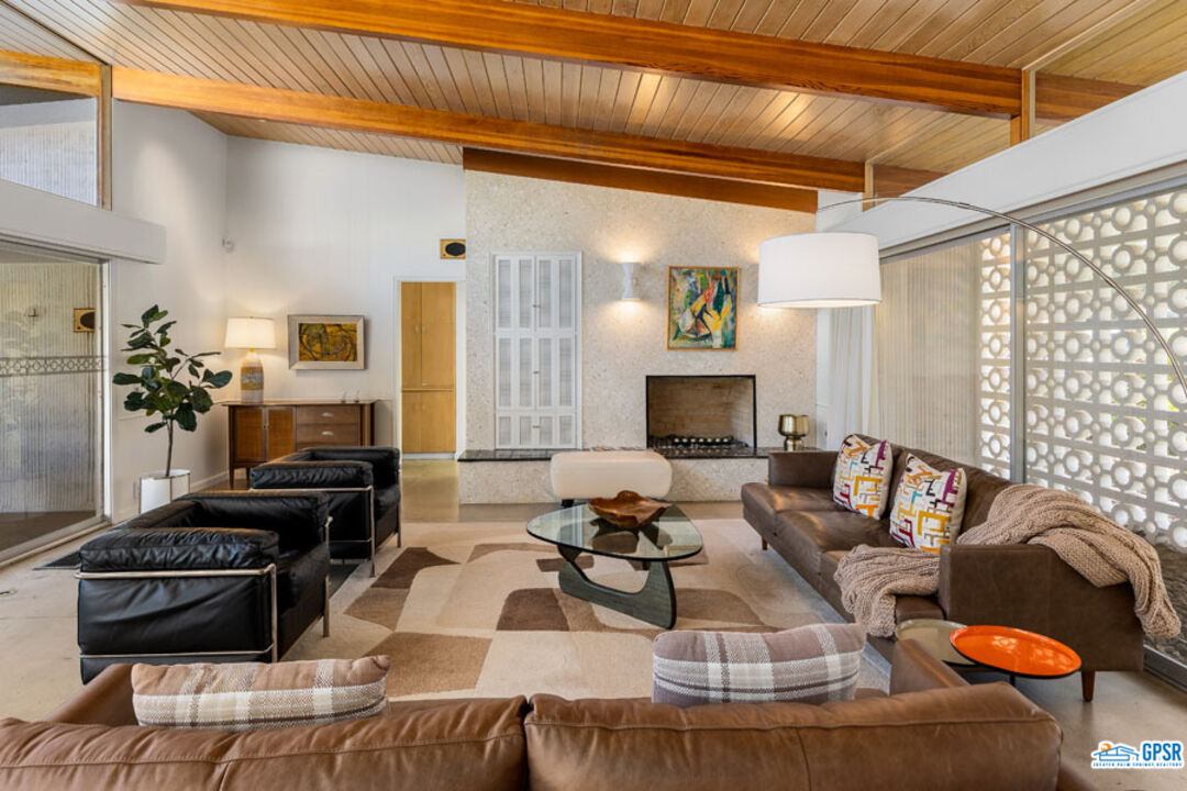 1090 Sagebrush Road Palm Springs, CA 92264 - Photo 11 of 49 a living room with furniture and a fireplace