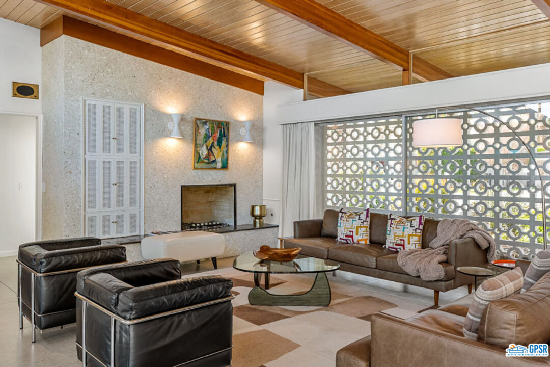 1090 Sagebrush Road Palm Springs, CA 92264 - Photo 12 of 49 a living room with furniture and a fireplace