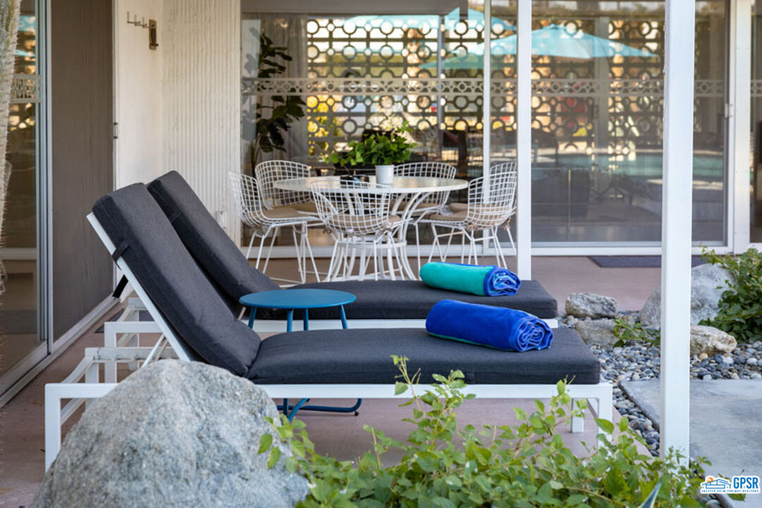 1090 Sagebrush Road Palm Springs, CA 92264 - Photo 17 of 49 a view of a patio with couches table and chairs and potted plants