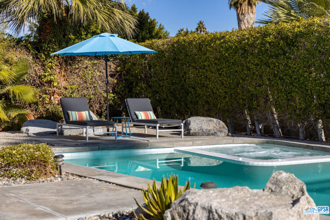 1090 Sagebrush Road Palm Springs, CA 92264 - Photo 22 of 49 a view of a swimming pool with a patio