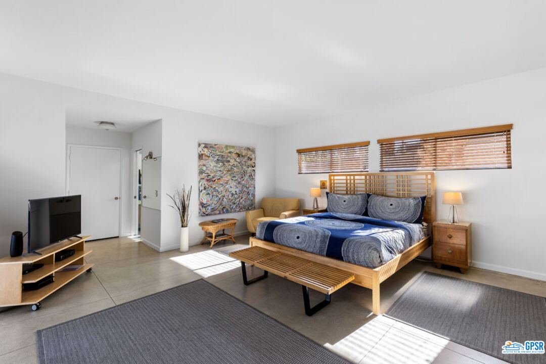 1090 Sagebrush Road Palm Springs, CA 92264 - Photo 26 of 49 a bedroom with a bed and flat screen tv