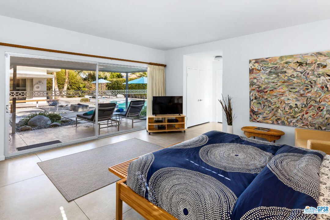 1090 Sagebrush Road Palm Springs, CA 92264 - Photo 27 of 49 a living room with furniture and a flat screen tv