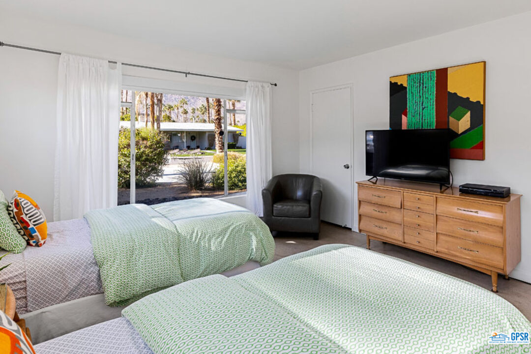 1090 Sagebrush Road Palm Springs, CA 92264 - Photo 33 of 49 a bedroom with furniture and flat screen tv