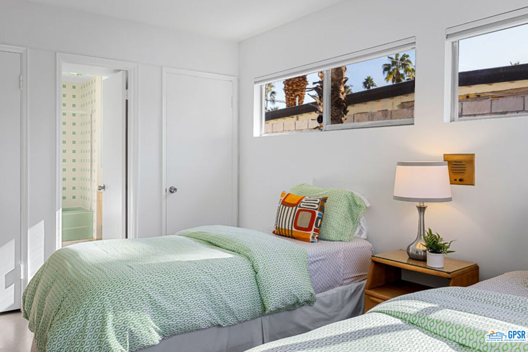 1090 Sagebrush Road Palm Springs, CA 92264 - Photo 34 of 49 a bedroom with bed and night stand