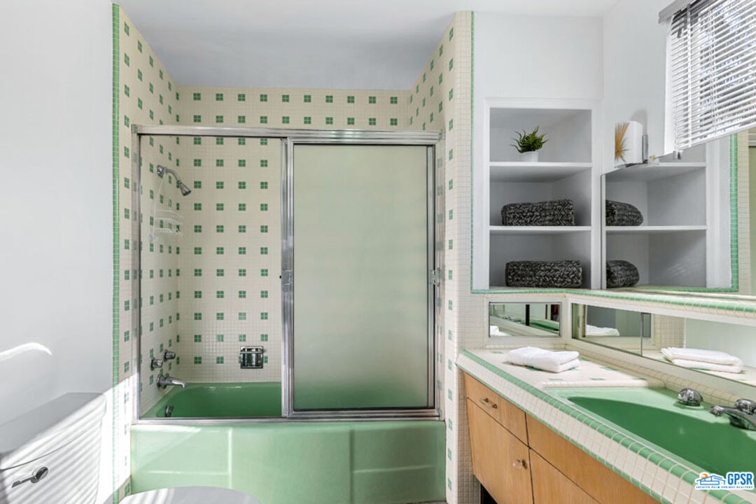 1090 Sagebrush Road Palm Springs, CA 92264 - Photo 36 of 49 a bathroom with a granite countertop sink and a mirror