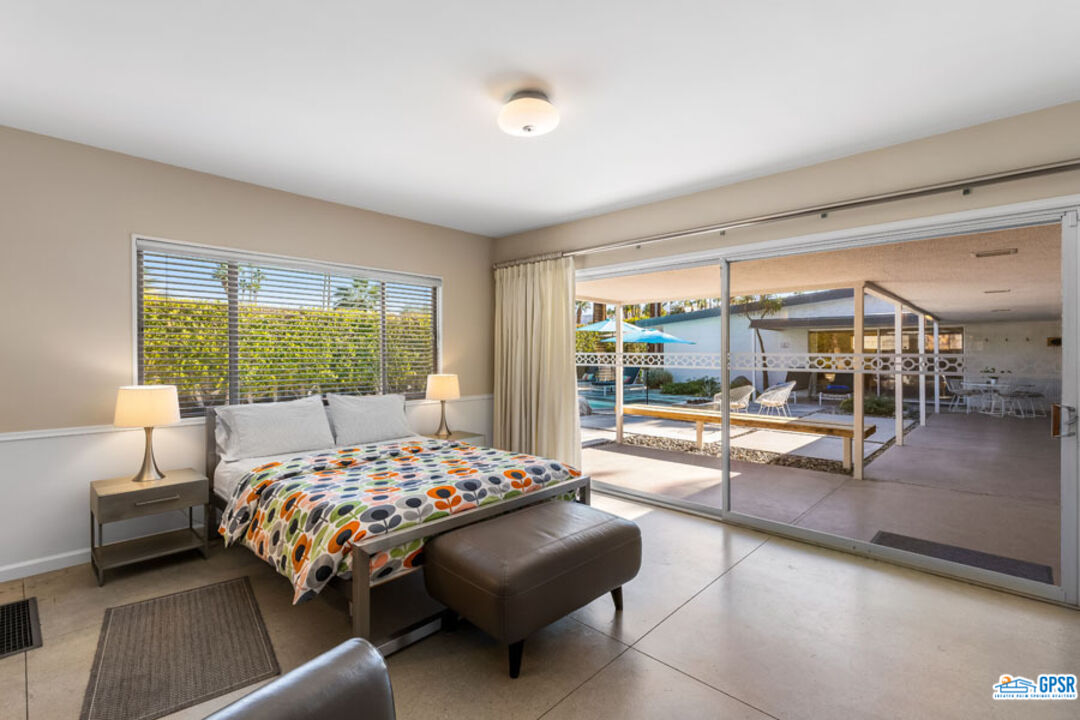 1090 Sagebrush Road Palm Springs, CA 92264 - Photo 37 of 49 a bedroom with a bed and a large window