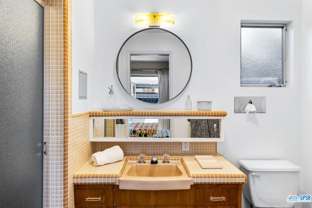 1090 Sagebrush Road Palm Springs, CA 92264 - Photo 40 of 49 a bathroom with a sink and a mirror