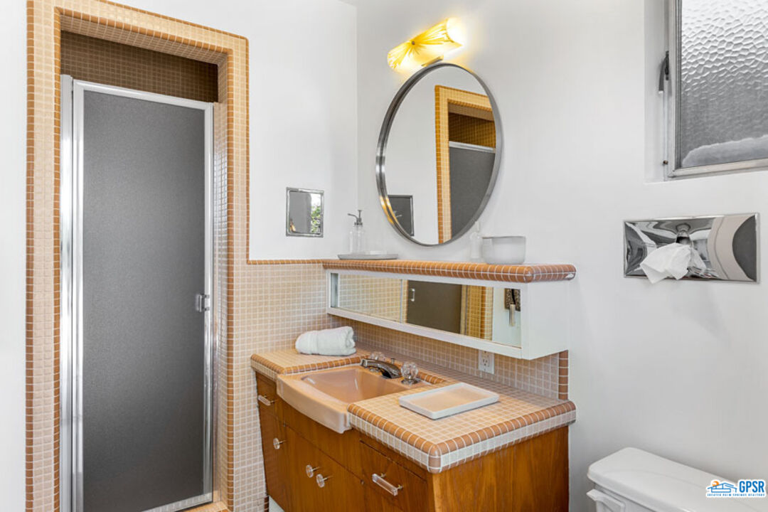 1090 Sagebrush Road Palm Springs, CA 92264 - Photo 41 of 49 a bathroom with a toilet a sink and a mirror