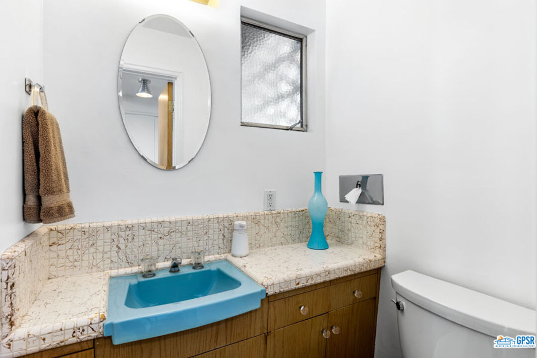 1090 Sagebrush Road Palm Springs, CA 92264 - Photo 42 of 49 a bathroom with a granite countertop sink and a mirror