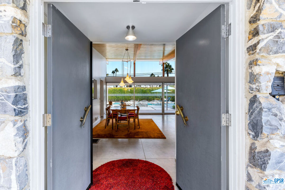 1090 Sagebrush Road Palm Springs, CA 92264 - Photo 7 of 49 a view of a living room and dining room