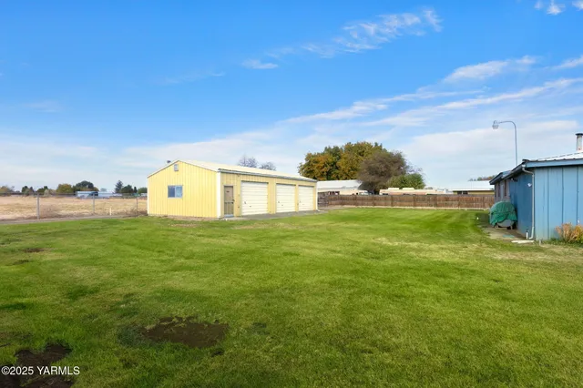 a view of an house with backyard space and balcony