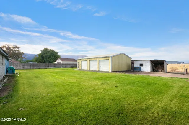 a house view with swimming pool in front of it