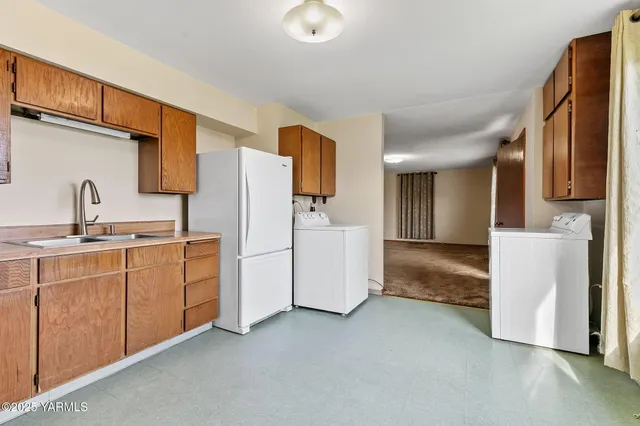 a kitchen with refrigerator and sink