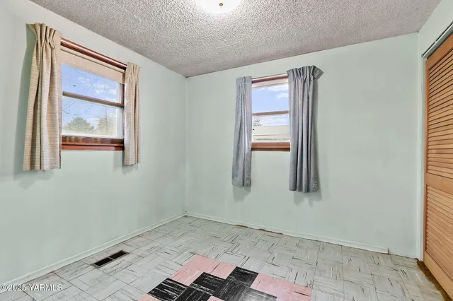 a view of walk in closet with empty room