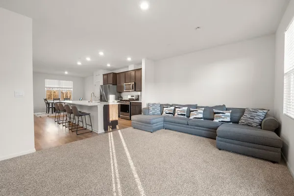 a living room with furniture and kitchen view
