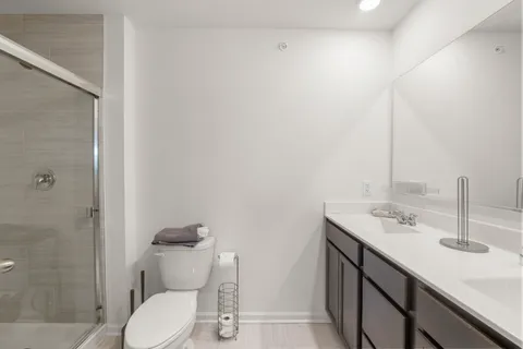 a bathroom with a sink toilet and shower