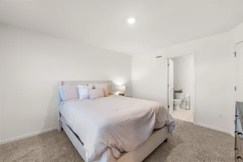 a bedroom with a bed and a desk
