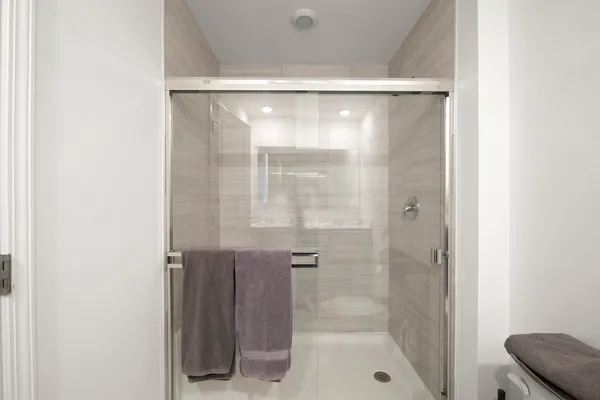 a bedroom with a bed and a night stand