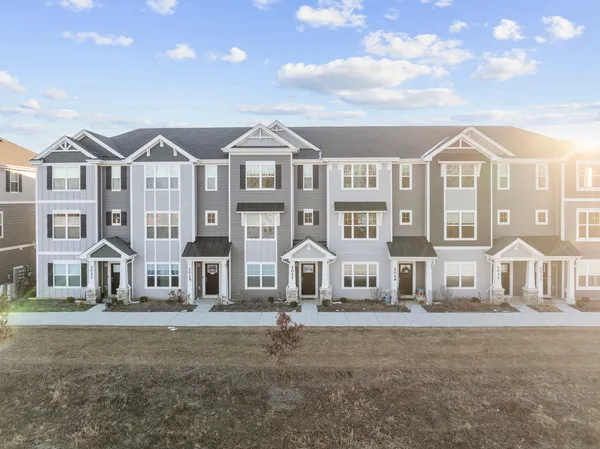 a front view of a residential apartment building with a yard