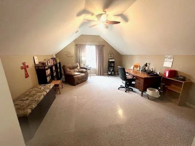 a view of a wooden bench and chairs in the garden