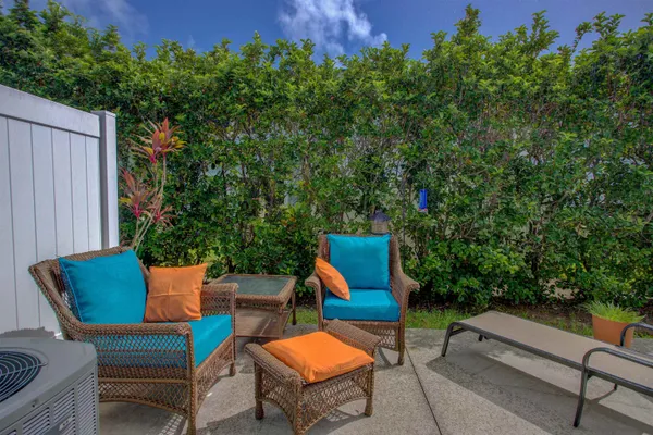 a backyard of a house with outdoor seating