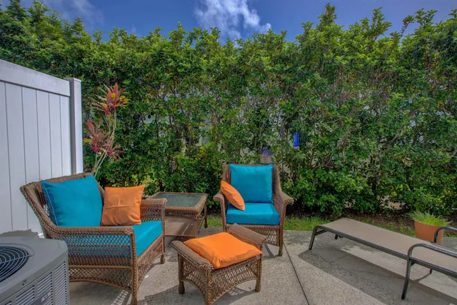 a backyard of a house with outdoor seating