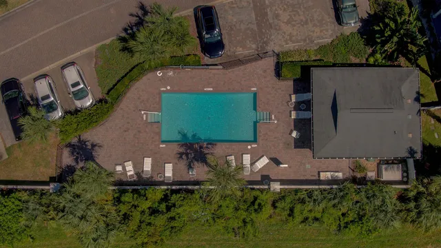 an aerial view of a house with garden space and street view