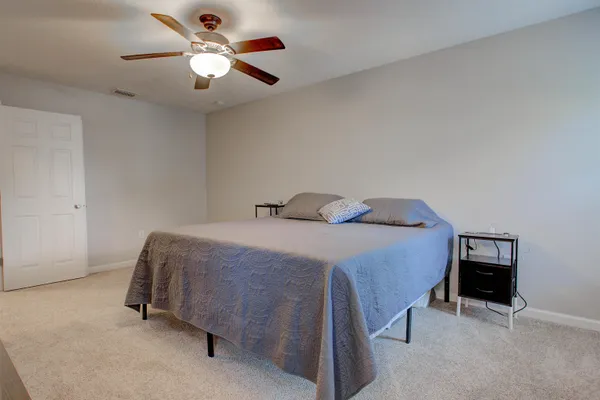 a bedroom with a bed and a chandelier