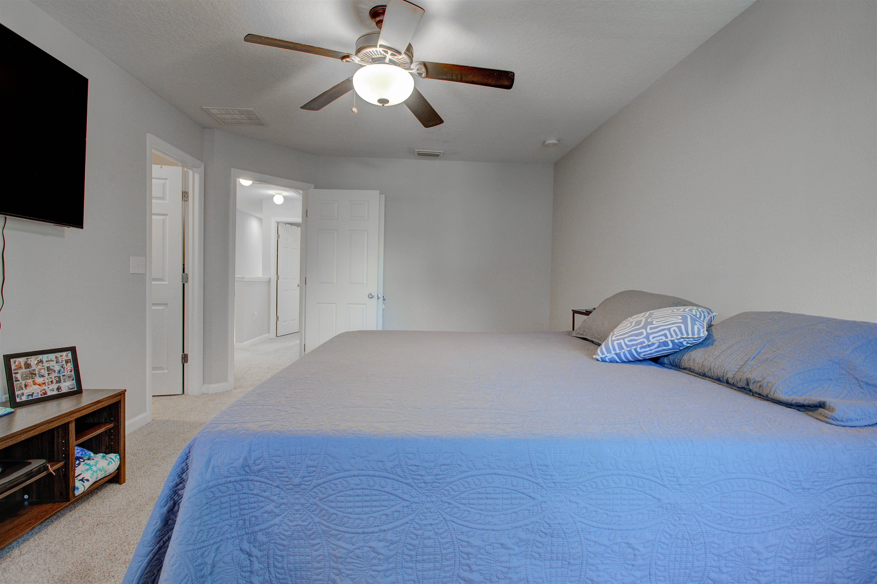 28 Islander Court St. Augustine, FL 32080 - Photo 10 of 23 a spacious bedroom with a bed and a flat tv screen on the dresser