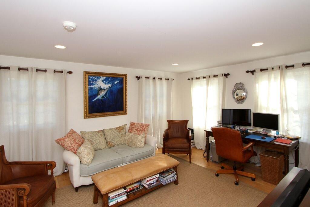 183 Stage Harbor Road Chatham, MA 02633 - Photo 11 of 35 a living room with furniture flat screen tv and a window