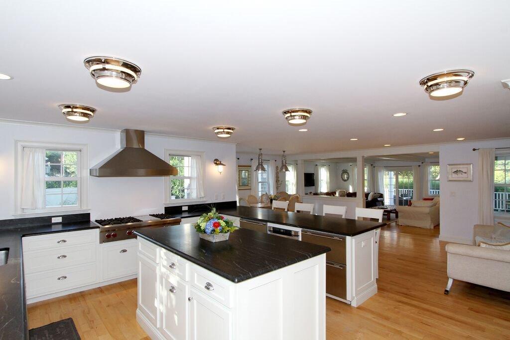 183 Stage Harbor Road Chatham, MA 02633 - Photo 3 of 35 a kitchen with a sink stove and cabinets