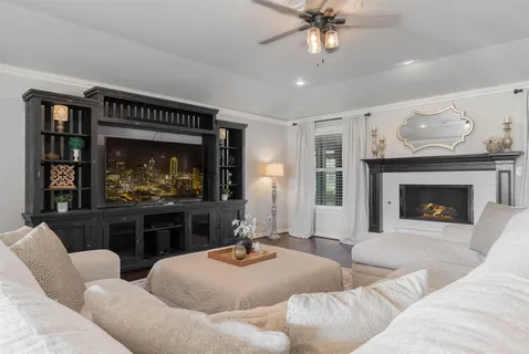 a living room with furniture a fireplace and a flat screen tv