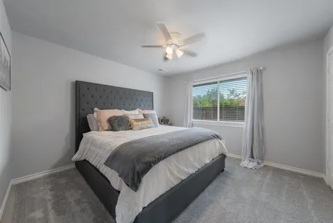 a bedroom with a bed and window